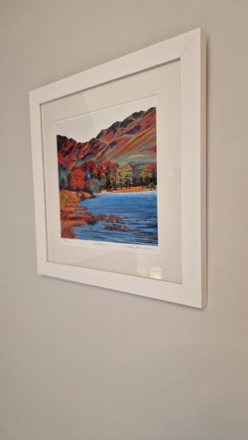 Framed Lake District print on a bedroom wall