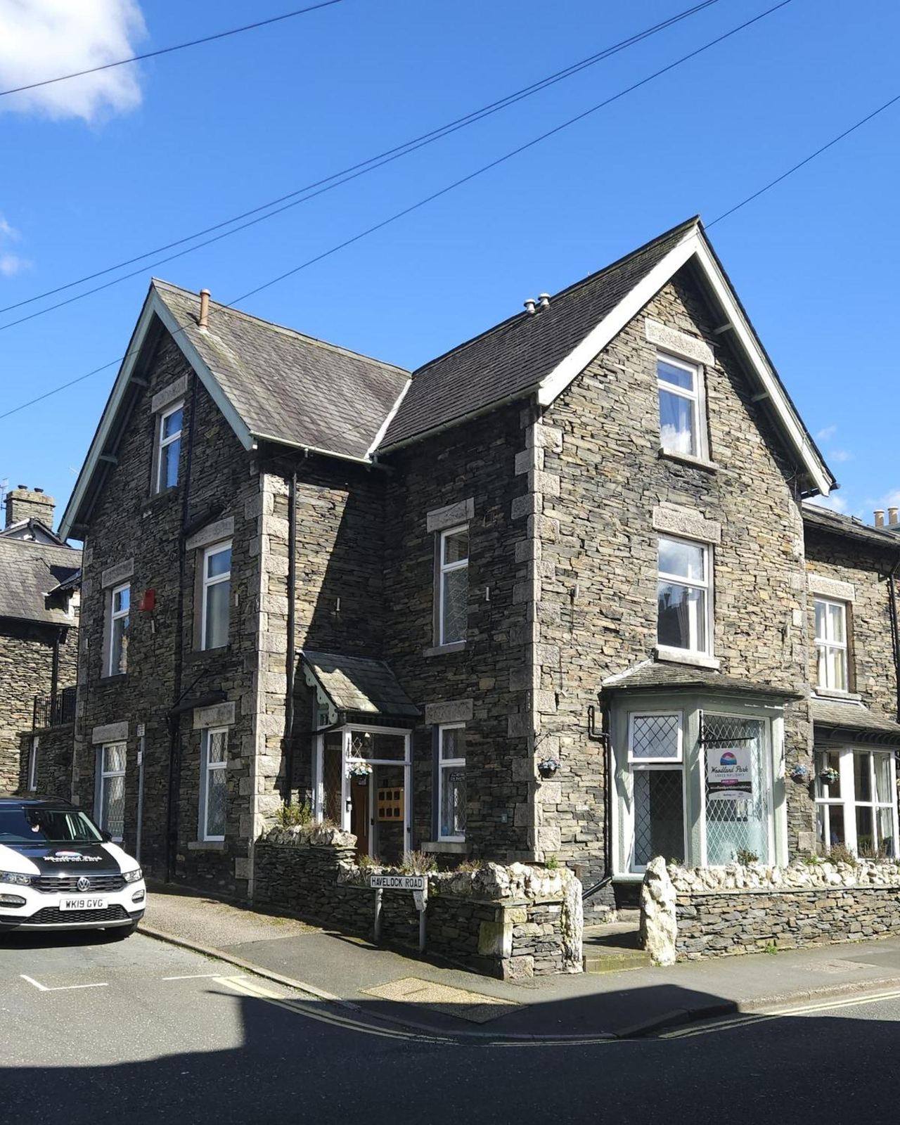 Stone guest house on Oak Street under a blue sky