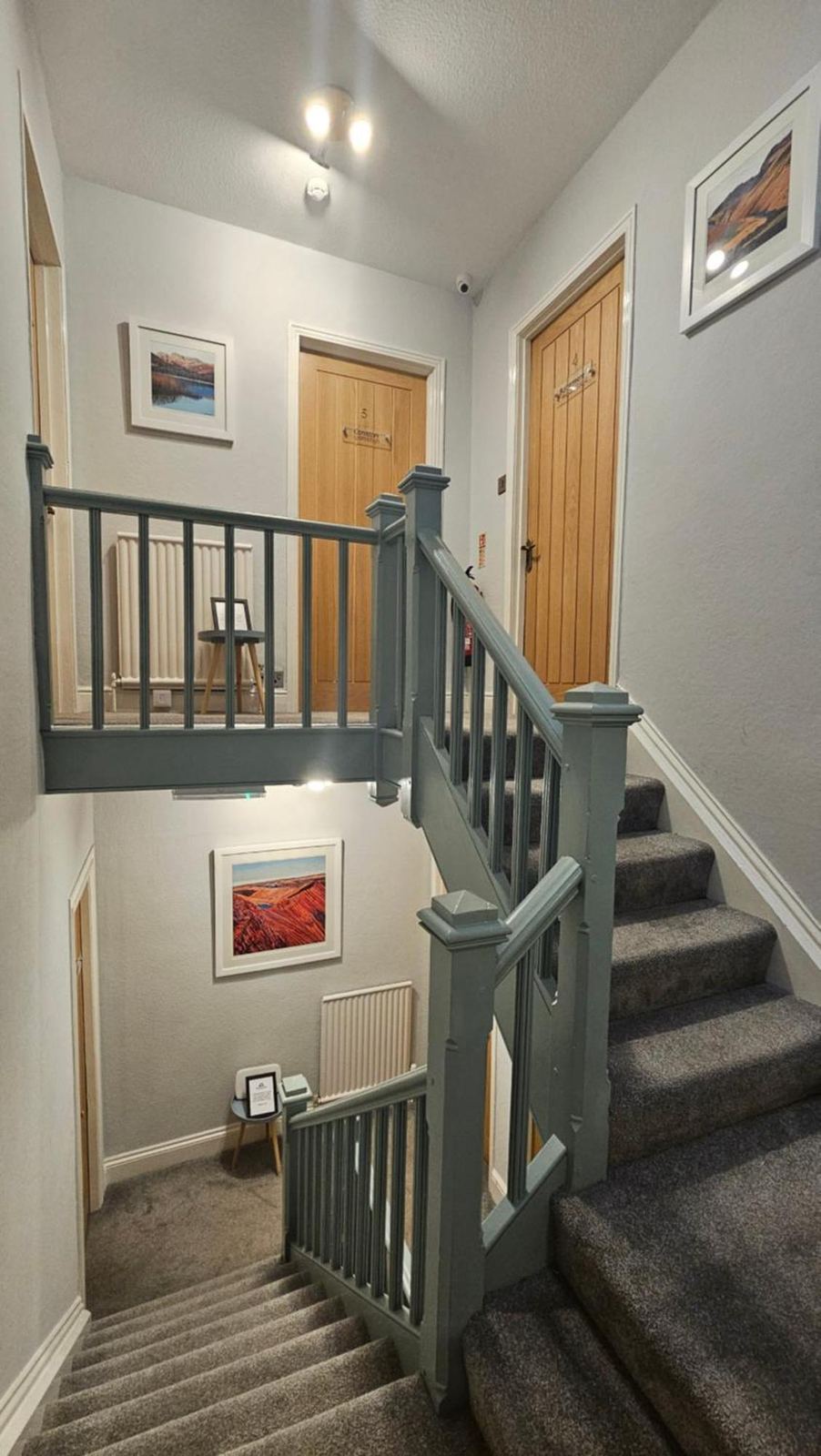 Staircase landing with painted balustrade and room doors